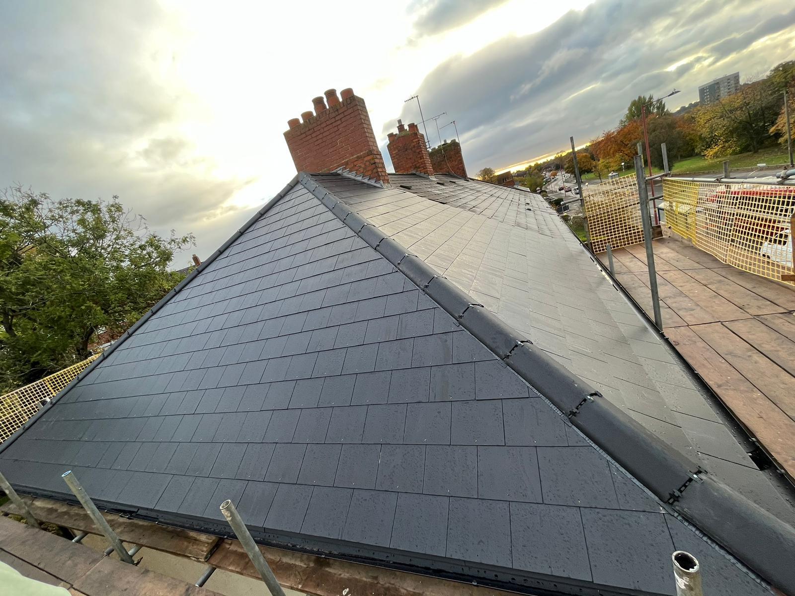 Finished natural slate hipped roof at dusk, Worcestershire re-roof by UK Roofing and Improvements Ltd