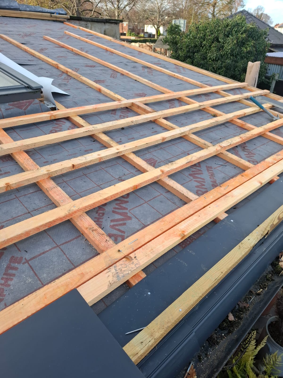 New treated battens fixed over breathable roofing membrane during a full re-roof