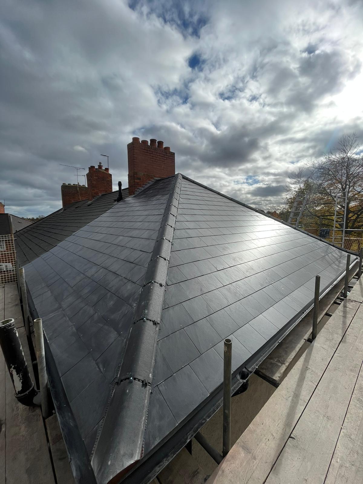 Completed modern slate hipped roof installed by UK Roofing and Improvements Ltd